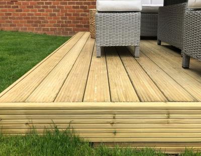 Softwood and hardwood decking installed in gardens and backyards, durable timber deck options for UK homes
