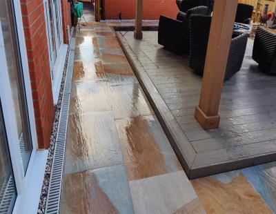 Comparison of a garden patio and decking area shown side by side