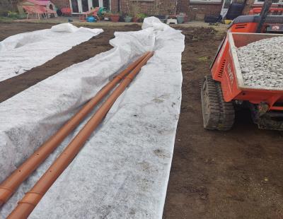 Garden drainage system with gravel and perforated pipe