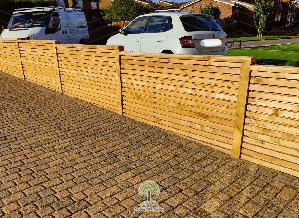 New cedar wood fencing installation with horizontal slats, enhancing privacy, durability, and modern kerb appeal.