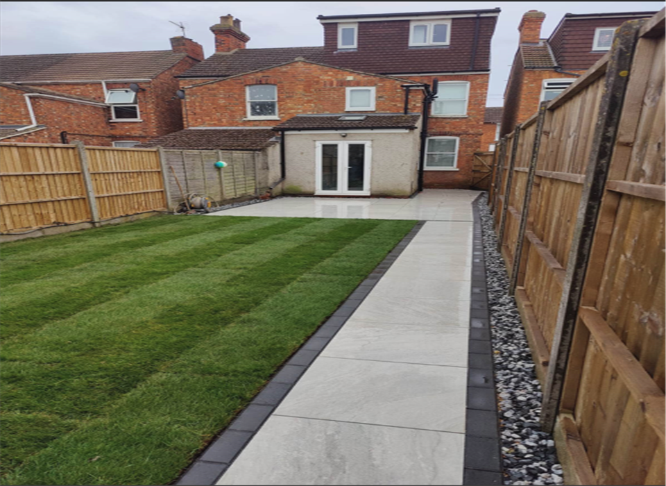 Modern garden renovation with porcelain paving and new lawn in Kempston